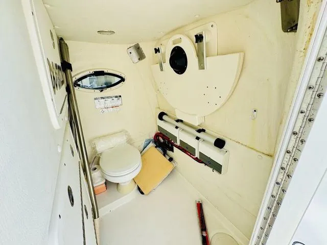 Slide: The Image of 2020 World Cat 32 boat interior with compact bathroom and storage features. - 23