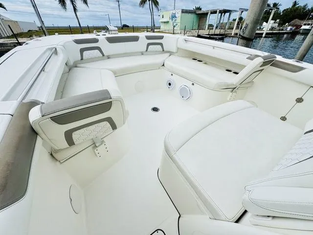 Slide: The Image of Spacious seating area on a 2020 World Cat 32 boat, featuring white and gray upholstery. - 27