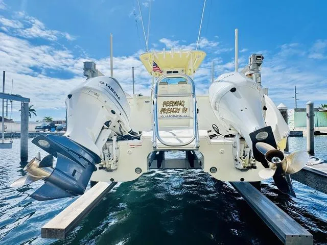 Slide: The Image of World Cat 32 boat with twin Yamaha engines docked, 2020 model, under a clear blue sky. - 3