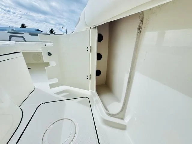Slide: The Image of 2020 World Cat 32 boat interior storage compartment with open hatch, showcasing sleek design. - 34