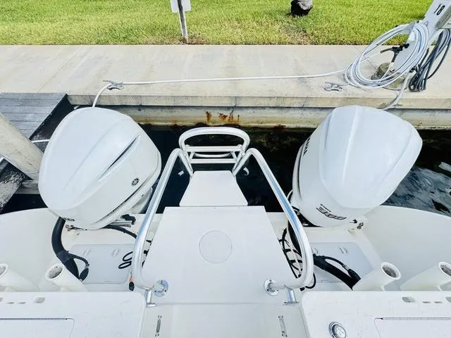 Slide: The Image of 2020 World Cat 32 boat with dual outboard motors docked at a marina. - 4