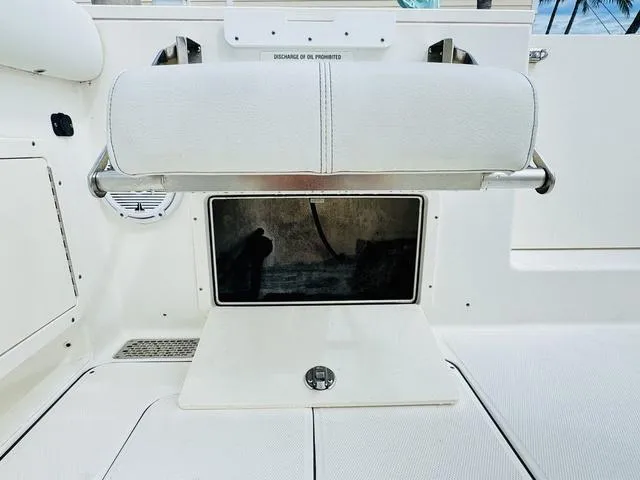 Slide: The Image of 2020 World Cat 32 boat interior with white seating and storage compartment. - 8