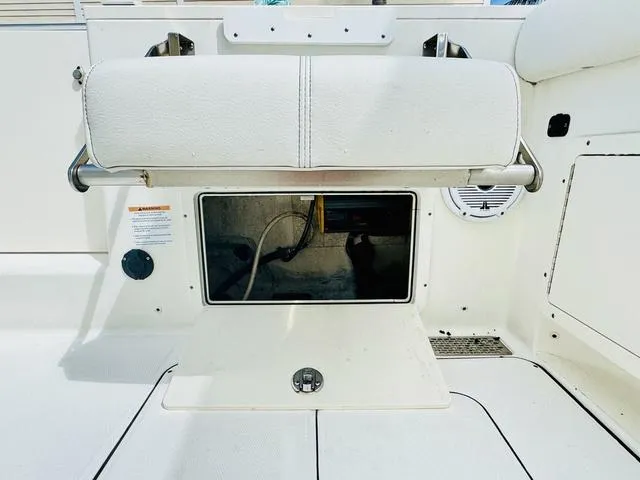 Slide: The Image of 2020 World Cat 32 boat interior with storage compartment and cushioned seat. - 9