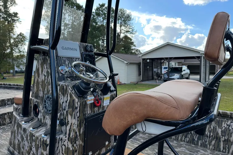 Slide: The Image of 2024 Avid 23 Mag boat interior with Garmin system and cushioned seating. - 4