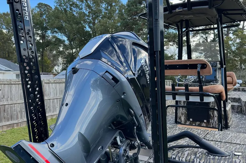 Slide: The Image of 2024 Avid 23 Mag boat with powerful outboard motor in a backyard setting. - 5