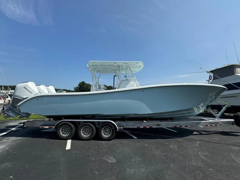 Slide: The Image of 2025 Yellowfin 34 Offshore boat on trailer under clear blue sky. - 2