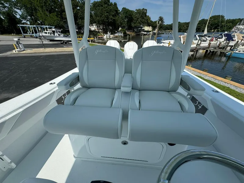Slide: The Image of 2025 Yellowfin 34 Offshore boat dashboard with navigation screens and controls. - 22