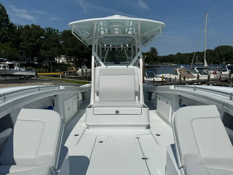 Slide: The Image of 2025 Yellowfin 34 Offshore boat with spacious deck and seating, docked at a marina. - 34