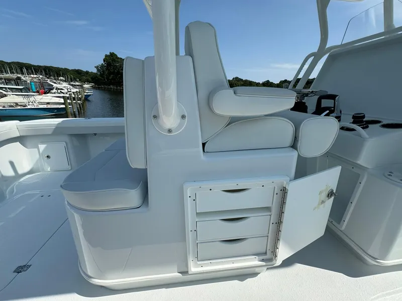 Slide: The Image of 2025 Yellowfin 34 Offshore boat interior with white seating and storage compartment. - 39