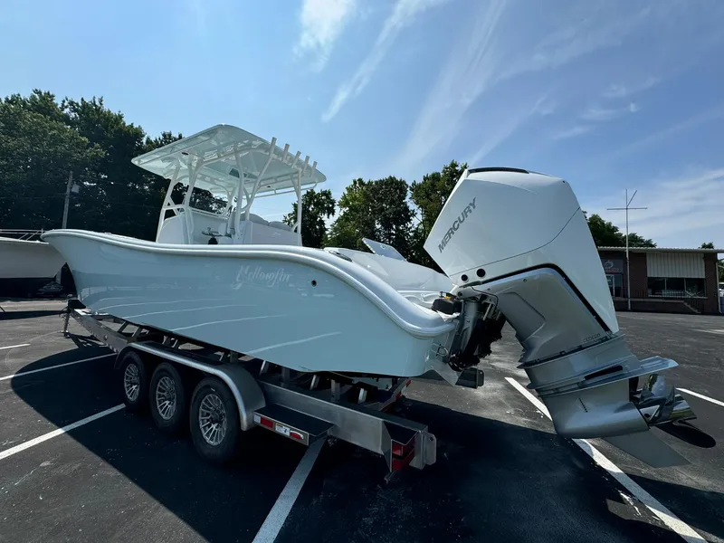 Slide: The Image of 2025 Yellowfin 34 Offshore boat on trailer with Mercury outboard engines in parking lot. - 7