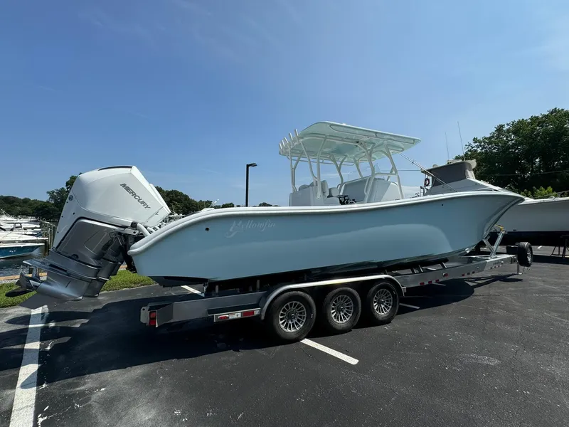 Slide: The Image of 2025 Yellowfin 34 Offshore boat on trailer, parked outdoors under clear sky. - 0