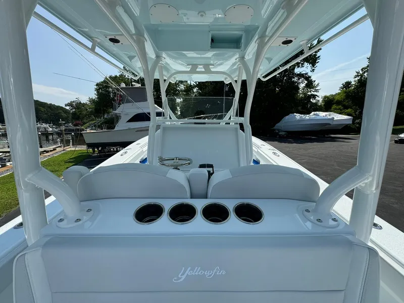 Slide: The Image of 2025 Yellowfin 34 Offshore boat interior with rod holders and seating. - 19