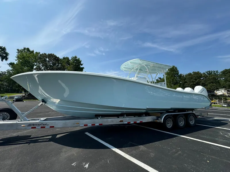 Slide: The Image of 2025 Yellowfin 34 Offshore boat on trailer in parking lot under clear sky. - 3