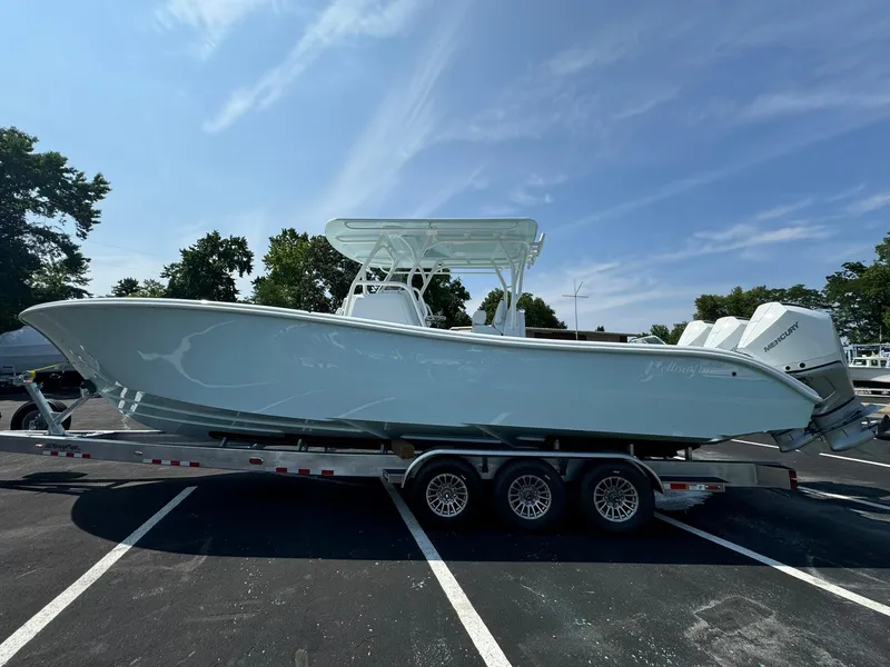Slide: The Image of 2025 Yellowfin 34 Offshore boat on a trailer in a parking lot. - 4