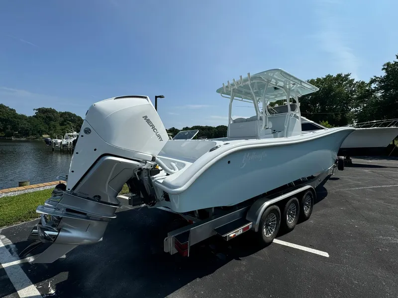 Slide: The Image of 2025 Yellowfin 34 Offshore boat on trailer, parked near water, featuring Mercury outboard engine. - 5