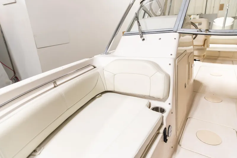 Slide: The Image of 2011 Grady-White Tournament 225 boat interior with white seating and sleek design. - 11