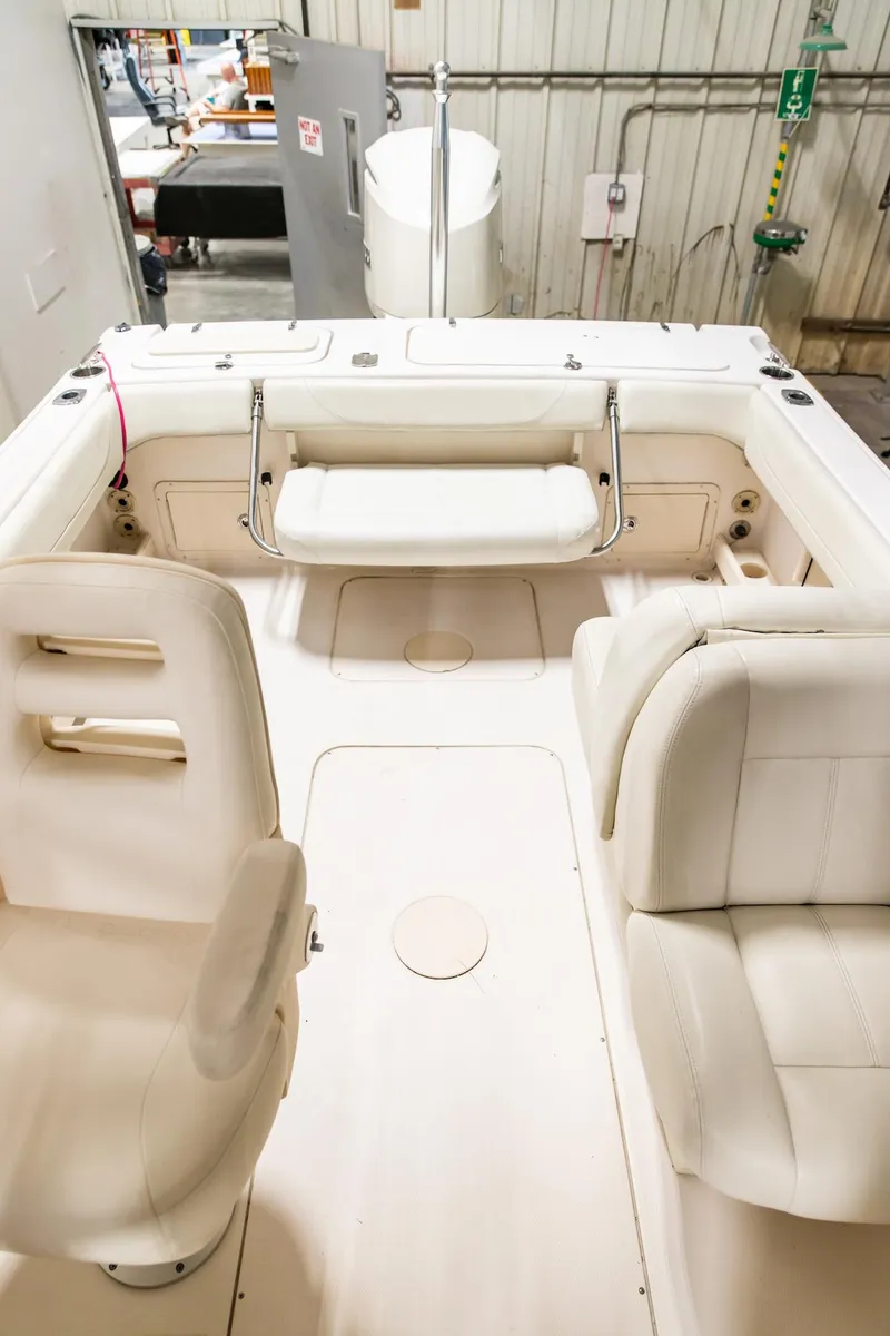 Slide: The Image of 2011 Grady-White Tournament 225 boat interior with white seating and clean design. - 12