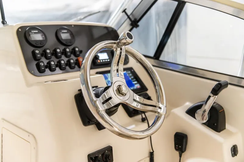 Slide: The Image of 2011 Grady-White Tournament 225 boat helm with steering wheel and control panel. - 15