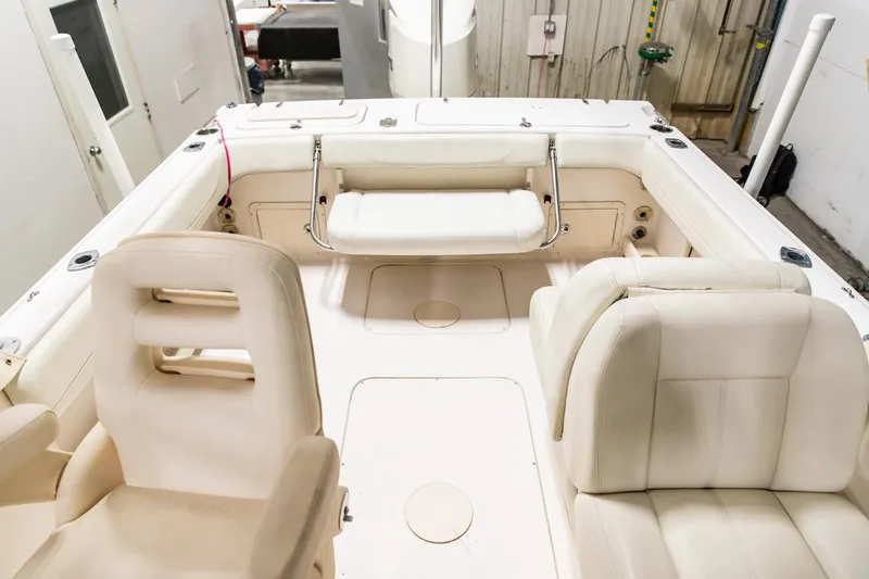 Slide: The Image of 2011 Grady-White Tournament 225 boat interior with seating and storage compartments. - 2
