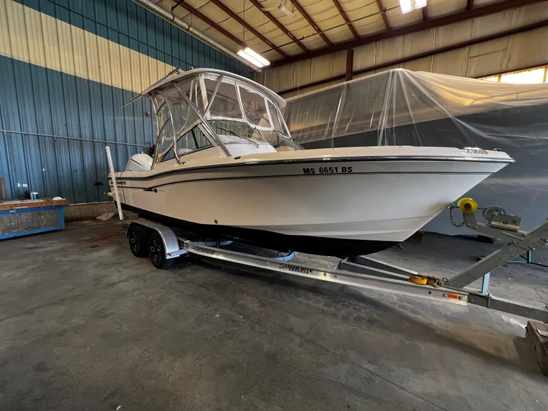 Slide: The Image of 2011 Grady-White Tournament 225 boat on trailer in indoor storage. - 23