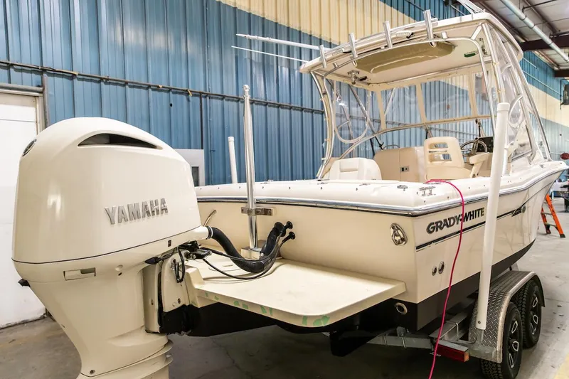 Slide: The Image of 2011 Grady-White Tournament 225 boat with Yamaha engine in a warehouse. - 3