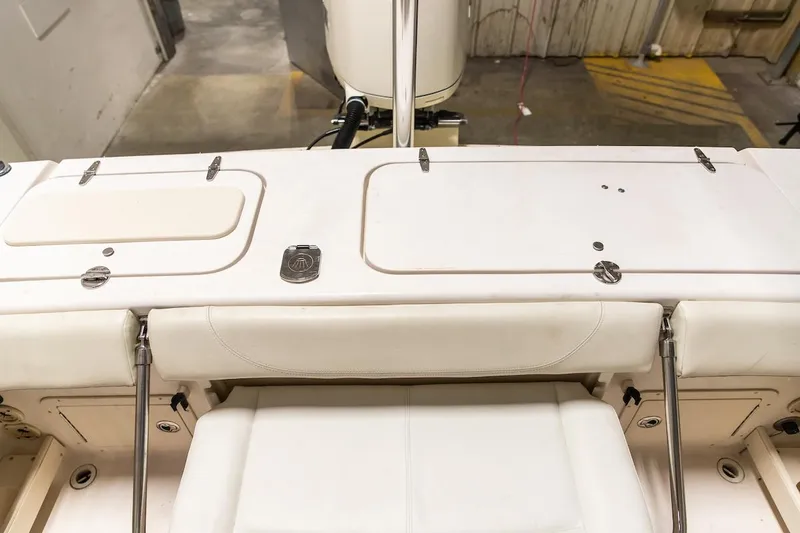 Slide: The Image of 2011 Grady-White Tournament 225 boat interior with white seating and storage compartments. - 42
