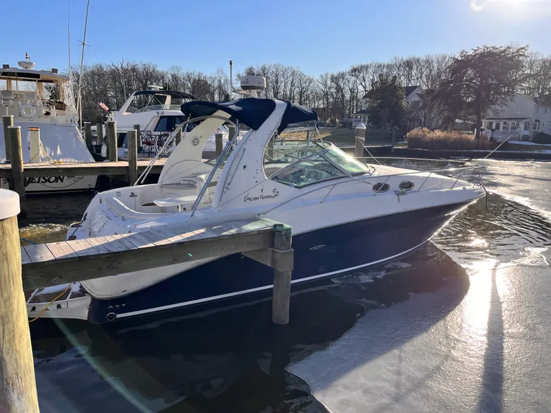 Slide: The Image of 2005 Sea Ray 320 Sundancer docked in a sunny marina setting. - 0