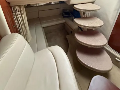 Slide: The Image of Interior of 2005 Sea Ray 320 Sundancer with beige seating and spiral stairs. - 10