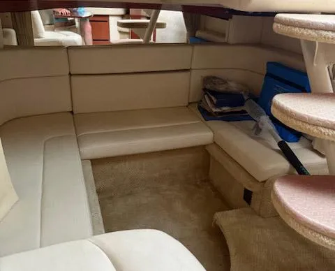Slide: The Image of Interior of 2005 Sea Ray 320 Sundancer with beige seating and carpeted flooring. - 12