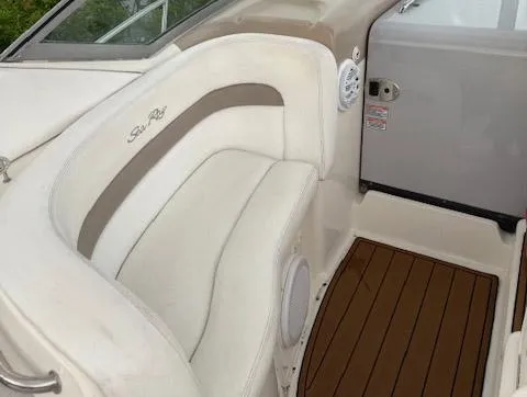 Slide: The Image of 2005 Sea Ray 320 Sundancer interior with white seating and wood flooring. - 13