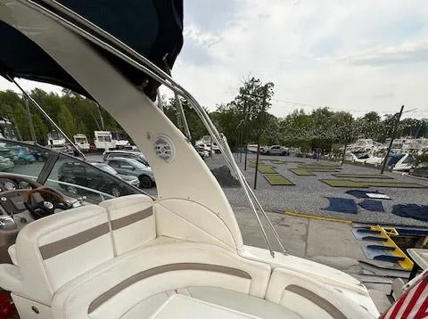 Slide: The Image of 2005 Sea Ray 320 Sundancer boat interior with seating, docked at marina. - 17