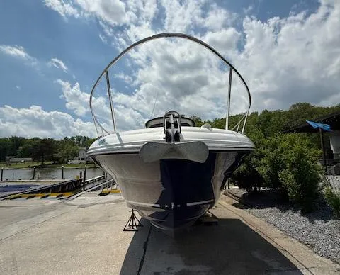 Slide: The Image of 2005 Sea Ray 320 Sundancer boat on a dock under a partly cloudy sky. - 2