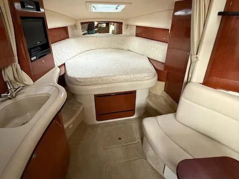 Slide: The Image of Interior of 2005 Sea Ray 320 Sundancer with bed, seating, and kitchenette. - 4