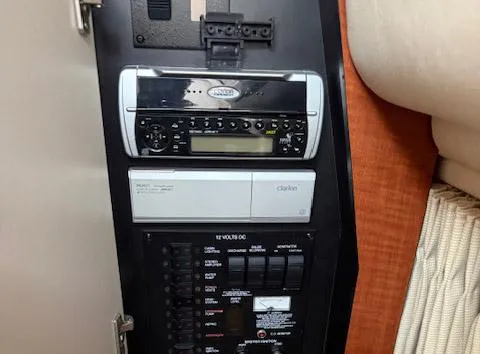 Slide: The Image of Control panel of a 2005 Sea Ray 320 Sundancer boat with audio system and switches. - 7