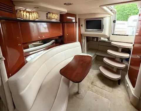 Slide: The Image of Interior of 2005 Sea Ray 320 Sundancer with elegant seating and wooden cabinetry. - 9
