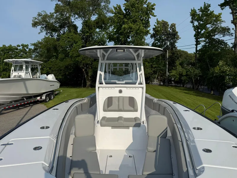 Slide: The Image of 2025 Cape Horn 32 XS boat with spacious seating and sleek design, docked outdoors. - 19