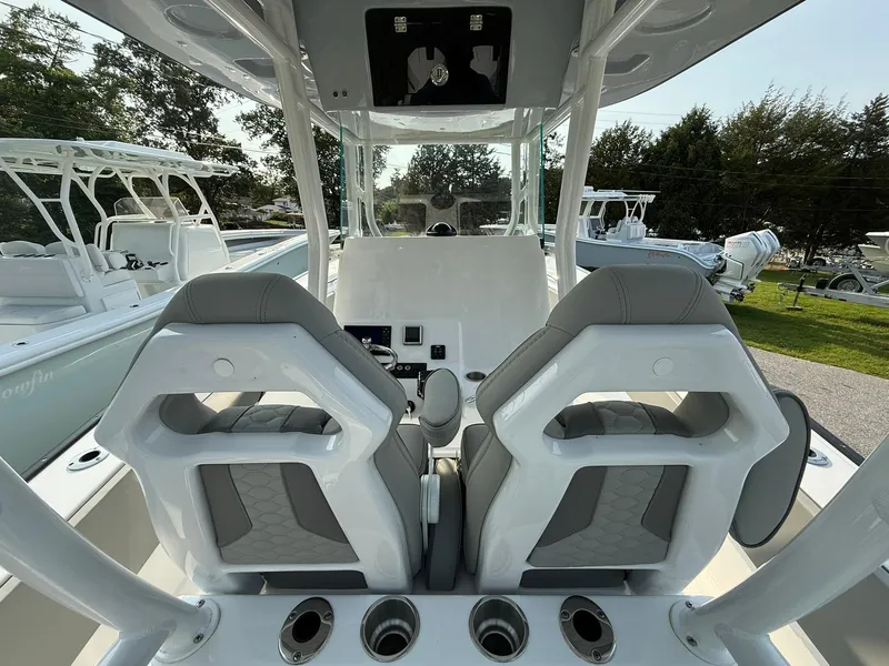 Slide: The Image of 2025 Cape Horn 32 XS boat interior with dual seats and control panel. - 10
