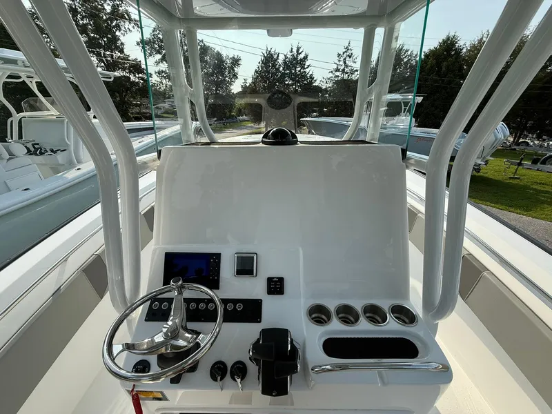 Slide: The Image of 2025 Cape Horn 32 XS boat console with steering wheel and controls. - 13