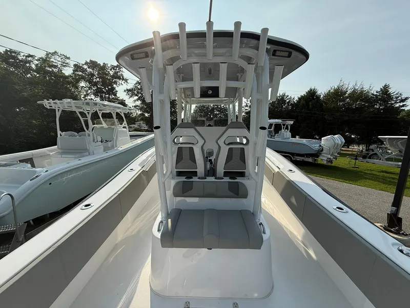Slide: The Image of 2025 Cape Horn 32 XS boat with center console and seating, displayed outdoors. - 7