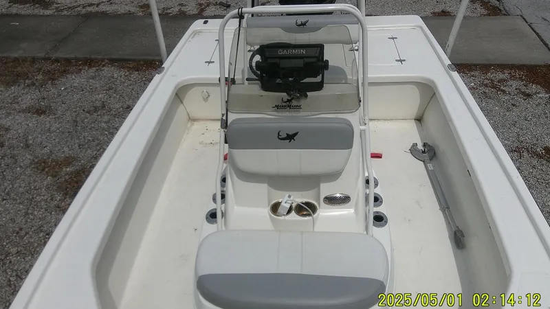 Slide: The Image of 2023 Mako 18 LTS boat interior with seating and steering console. - 1