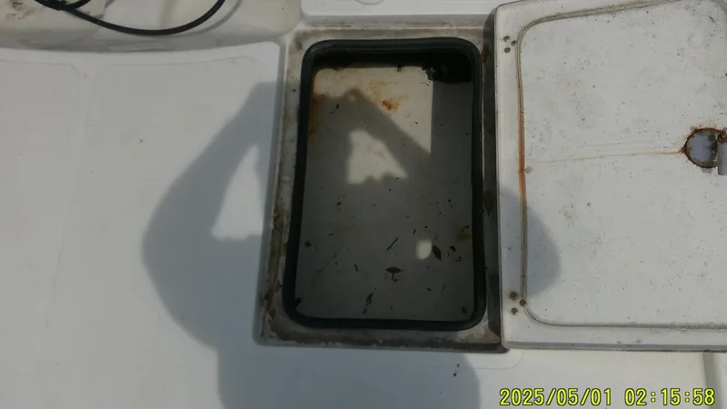 Slide: The Image of Open storage compartment on a 2023 Mako 18 LTS boat, showing interior details. - 10