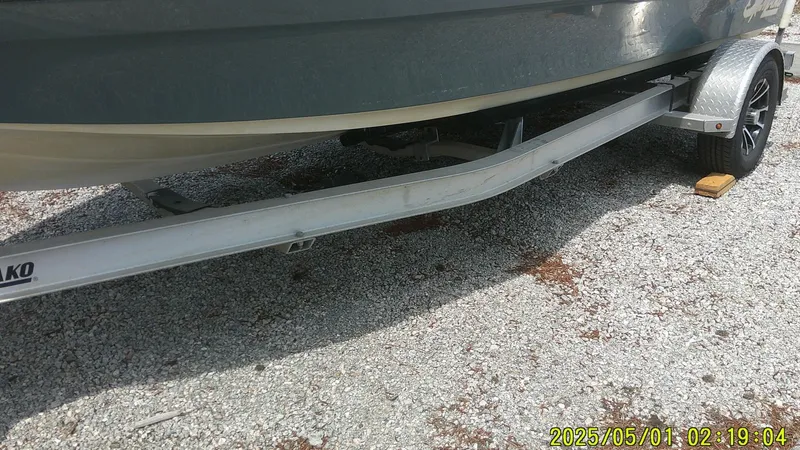 Slide: The Image of 2023 Mako 18 LTS boat on trailer, parked on gravel surface. - 13