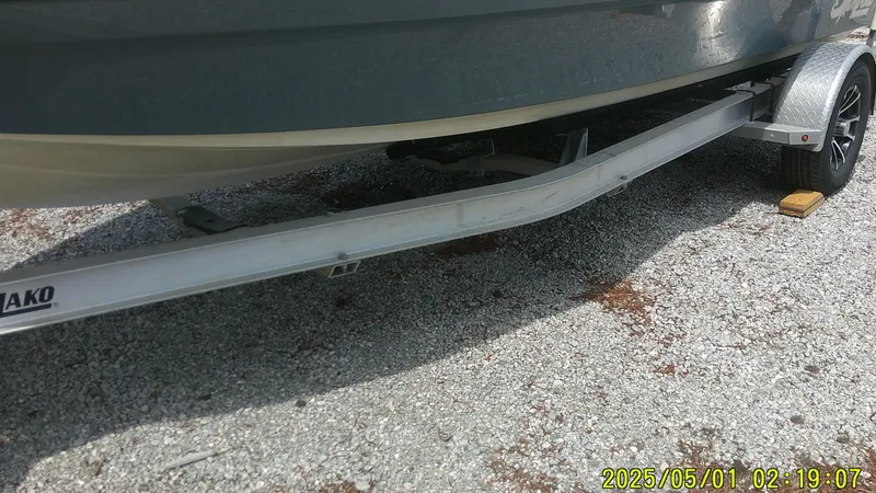 Slide: The Image of 2023 Mako 18 LTS boat on trailer, gravel surface, date stamp visible. - 14