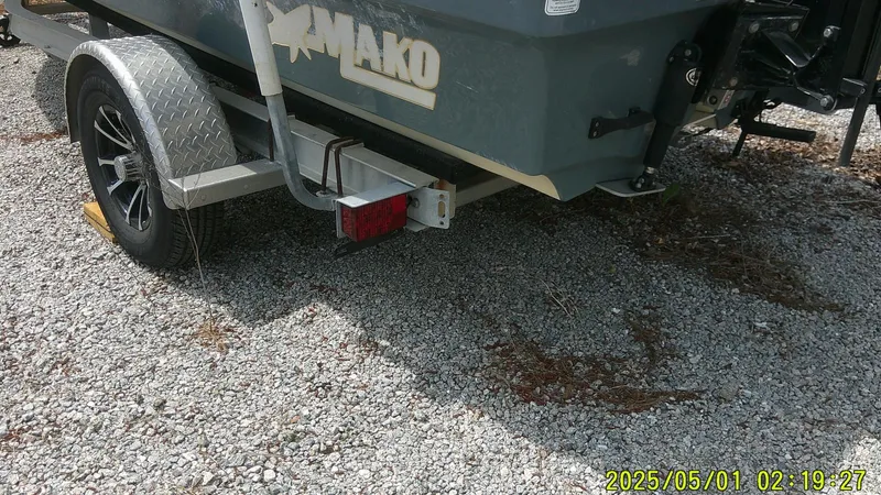 Slide: The Image of 2023 Mako 18 LTS boat on trailer, parked on gravel. - 16