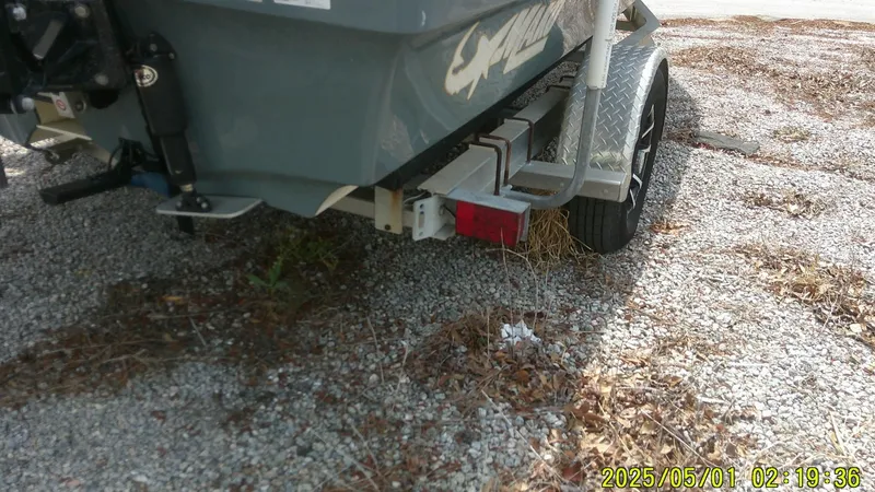 Slide: The Image of Rear view of a 2023 Mako 18 LTS boat on a gravel surface. - 17