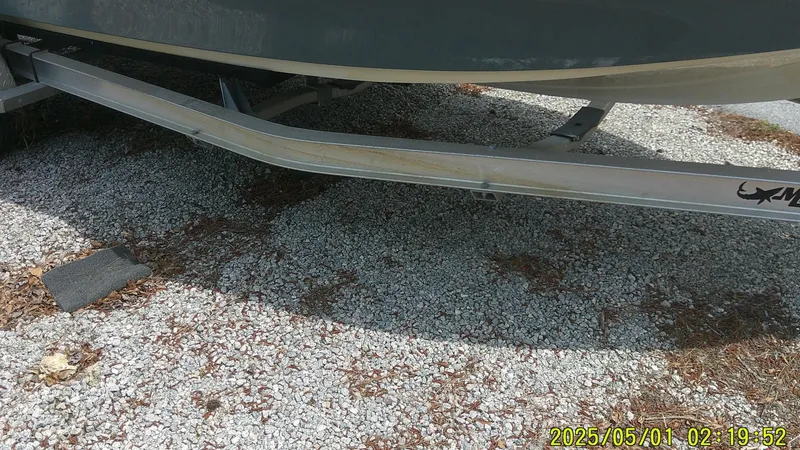 Slide: The Image of 2023 Mako 18 LTS boat trailer on gravel surface. - 19