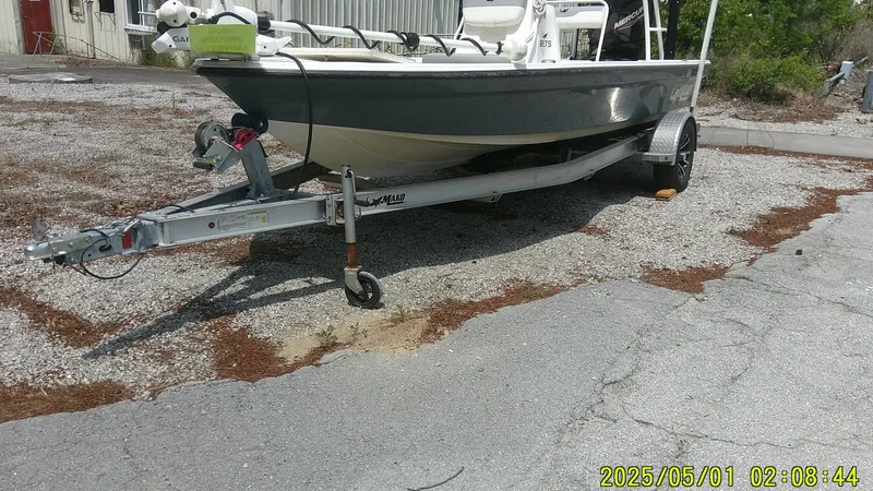 Slide: The Image of 2023 Mako 18 LTS boat on trailer, parked on gravel surface. - 20