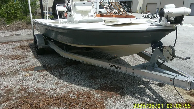 Slide: The Image of 2023 Mako 18 LTS boat on trailer, parked outdoors, side view. - 21