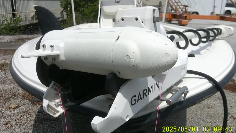 Slide: The Image of 2023 Mako 18 LTS boat with Garmin trolling motor, docked outdoors. - 25