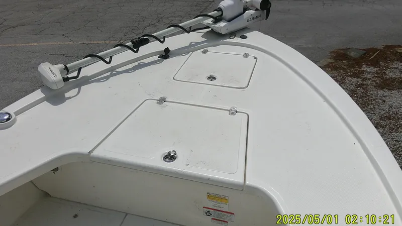 Slide: The Image of 2023 Mako 18 LTS boat deck with storage compartments and trolling motor. - 27